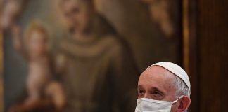 Pope Francis wearing white mask